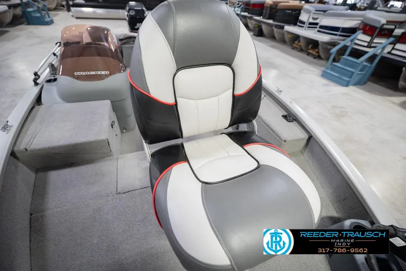 Slide: The Image of 2007 Tracker Tournament V-18 boat seat with gray, white, and red accents in showroom. - 38