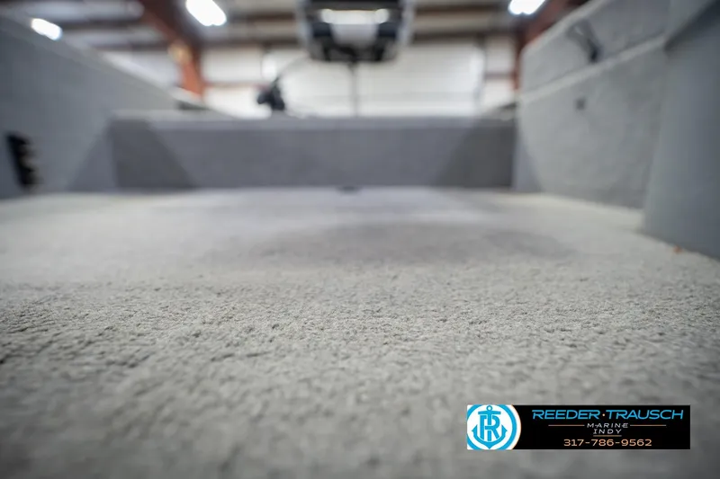 Slide: The Image of 2007 Tracker Tournament V-18 boat interior with carpeted flooring in a showroom. - 41