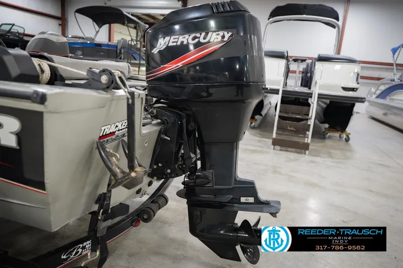 Slide: The Image of 2007 Tracker Tournament V-18 boat with Mercury outboard motor in a showroom. - 42