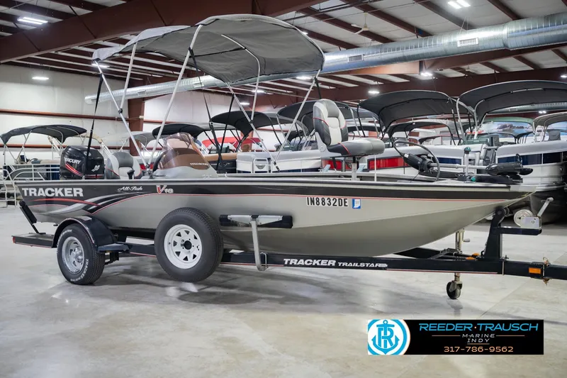 Slide: The Image of 2007 Tracker Tournament V-18 boat with canopy in showroom, displayed on trailer. - 6