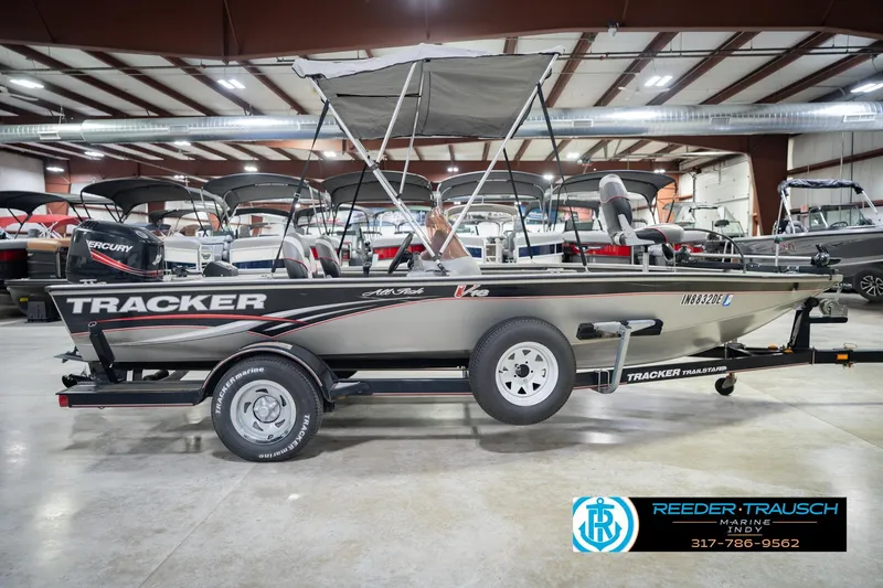 Slide: The Image of 2007 Tracker Tournament V-18 fishing boat in showroom, featuring Mercury outboard motor. - 7