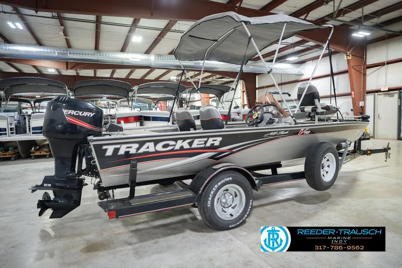 Slide: The Image of 2007 Tracker Tournament V-18 boat with Mercury engine in showroom setting. - 8