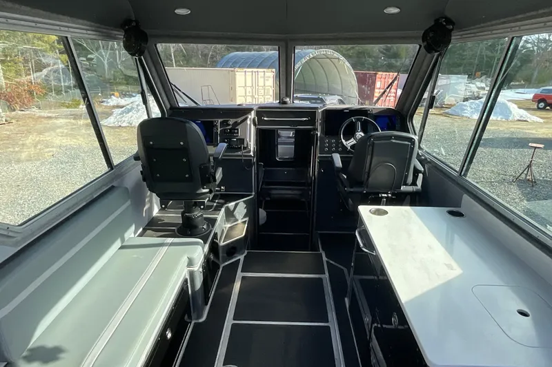Slide: The Image of Interior of 2025 Life Proof 31 GT Coupe boat with modern seating and controls. - 11