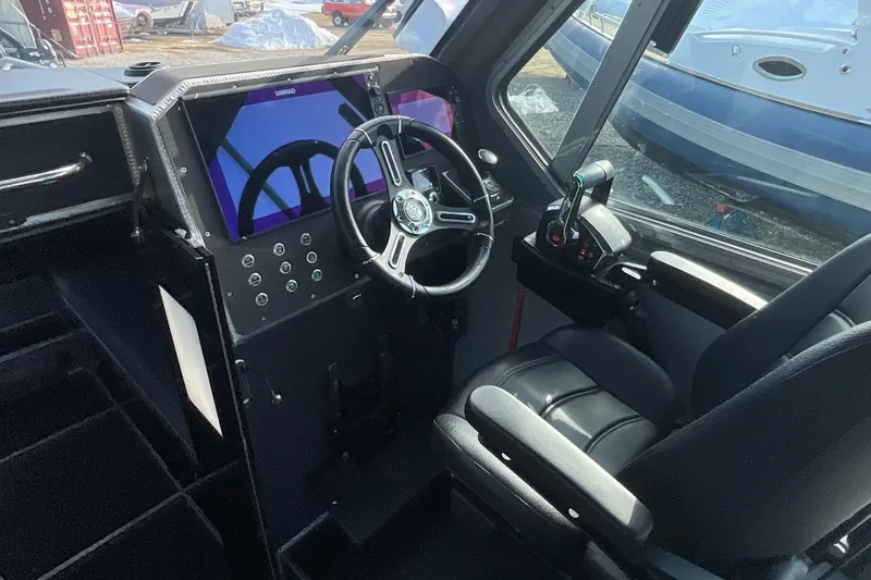 Slide: The Image of 2025 Life Proof 31 GT Coupe boat interior with modern steering and control panel. - 12