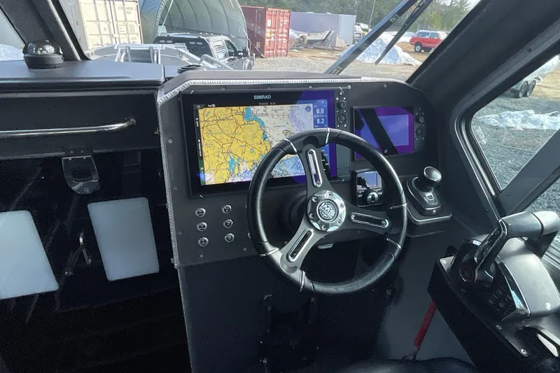 Slide: The Image of Interior of 2025 Life Proof 31 GT Coupe boat with navigation system and steering wheel. - 19