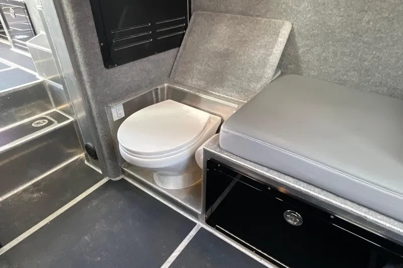 Slide: The Image of Interior of 2025 Life Proof 31 GT Coupe featuring compact toilet and cushioned seating. - 22
