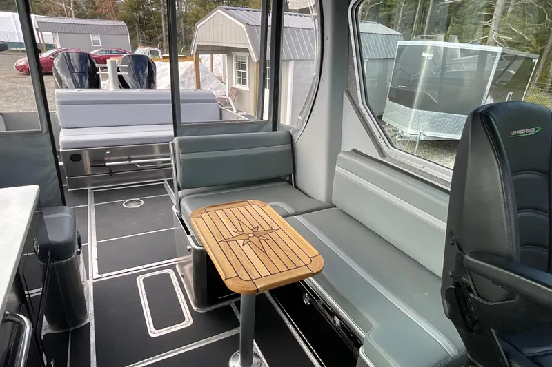 Slide: The Image of Interior of 2025 Life Proof 31 GT Coupe boat with seating and wooden table. - 27