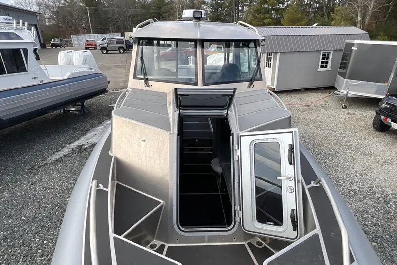 Slide: The Image of 2025 Life Proof 31 GT Coupe boat with open cabin door, docked outdoors. - 29