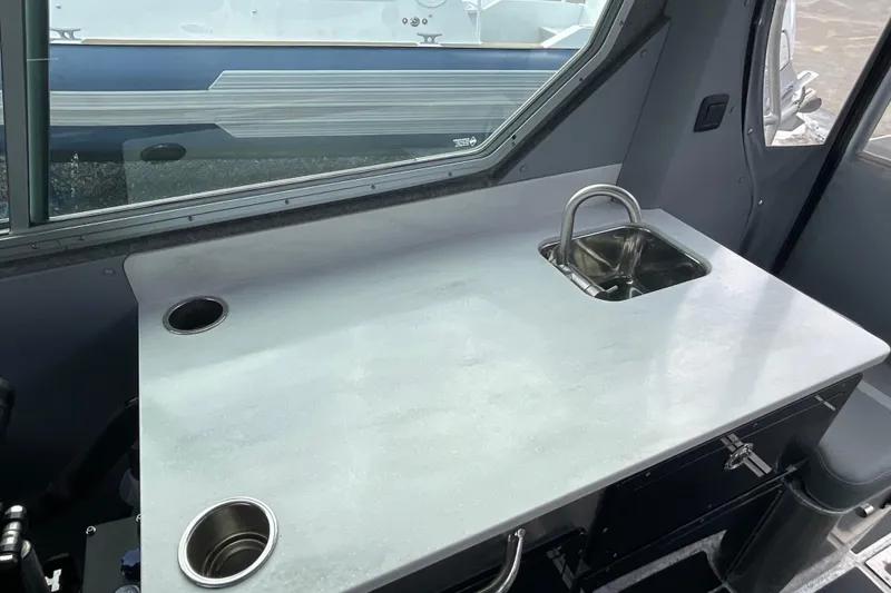 Slide: The Image of Interior of 2025 Life Proof 31 GT Coupe featuring a sleek countertop and compact sink. - 31