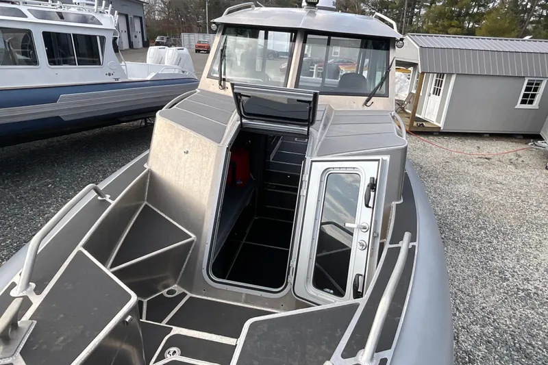 Slide: The Image of 2025 Life Proof 31 GT Coupe boat with open cabin door, docked outdoors. - 32