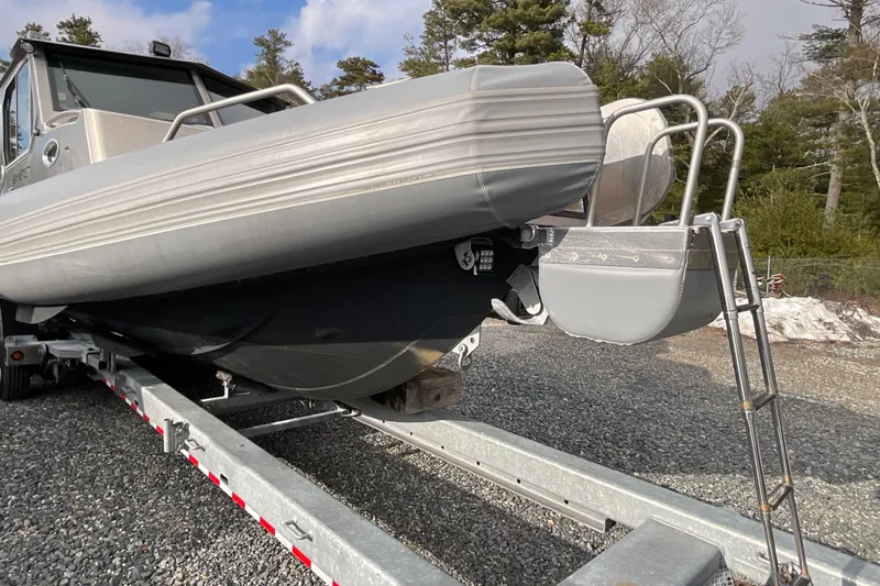 Slide: The Image of 2025 Life Proof 31 GT Coupe boat on trailer, parked outdoors. - 34