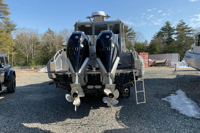 Slide: The Image of 2025 Life Proof 31 GT Coupe boat with dual outboard motors, parked outdoors. - 4