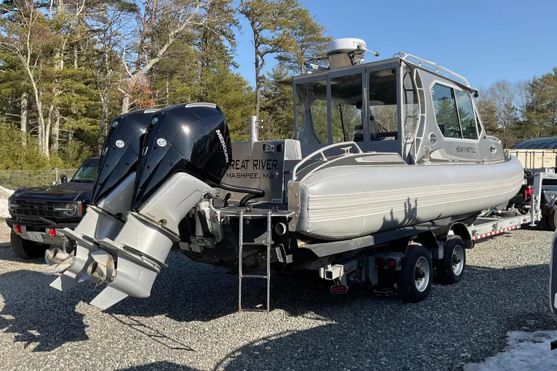 Slide: The Image of 2025 Life Proof 31 GT Coupe boat on trailer with dual Mercury engines, parked outdoors. - 6