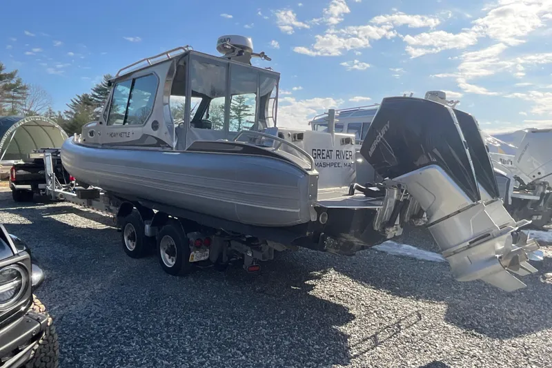 Slide: The Image of 2025 Life Proof 31 GT Coupe boat on trailer, parked outdoors under blue sky. - 8