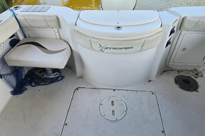 Slide: The Image of 2004 Seaswirl Striper 2101 Walkaround O/B boat interior with seating and storage. - 16