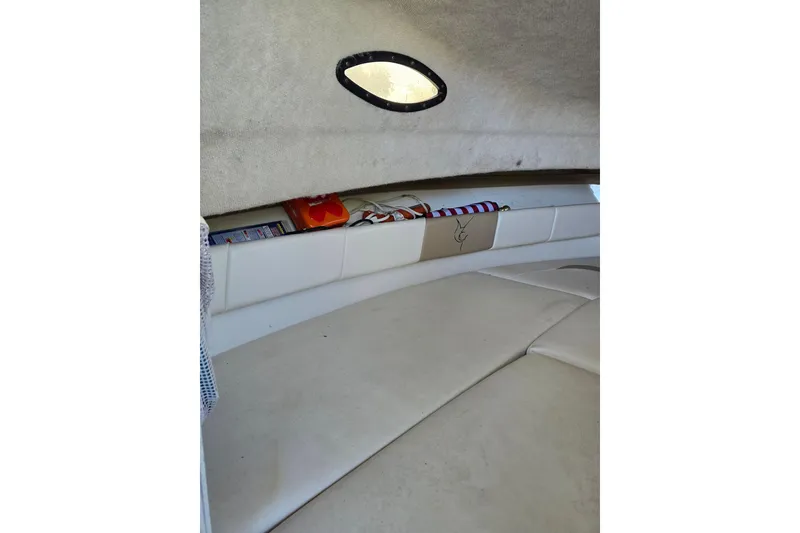 Slide: The Image of 2004 Seaswirl Striper 2101 Walkaround O/B cabin interior with storage and seating. - 6