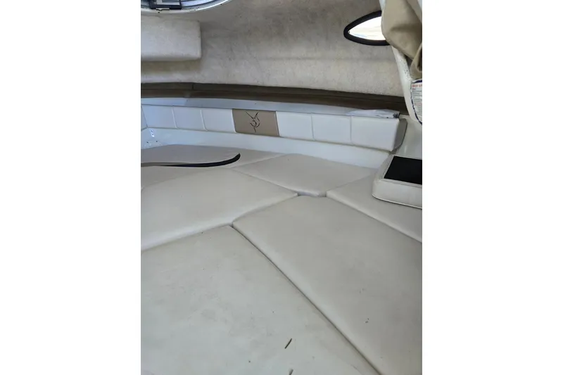 Slide: The Image of 2004 Seaswirl Striper 2101 Walkaround O/B cabin interior with cushioned seating. - 7