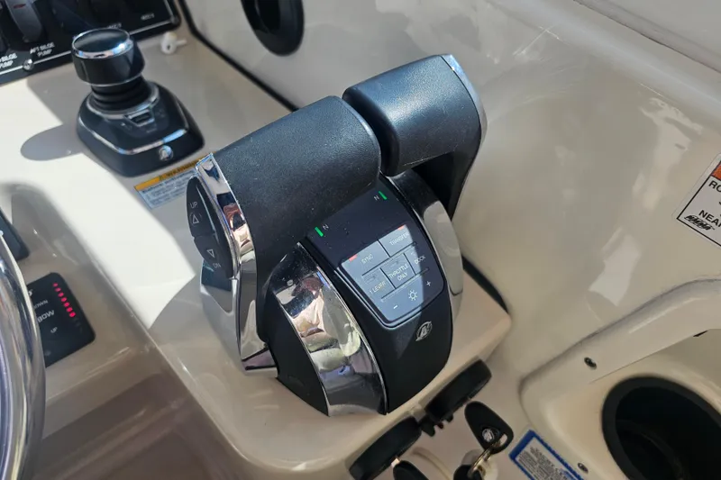 Slide: The Image of Close-up of 2018 Boston Whaler 315 Conquest throttle controls on boat dashboard. - 12