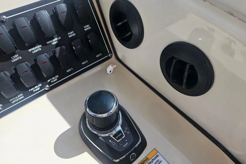 Slide: The Image of Control panel of 2018 Boston Whaler 315 Conquest boat with switches and joystick. - 13