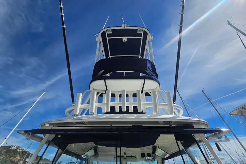 Slide: The Image of 2018 Boston Whaler 315 Conquest boat tower against a clear blue sky. - 15