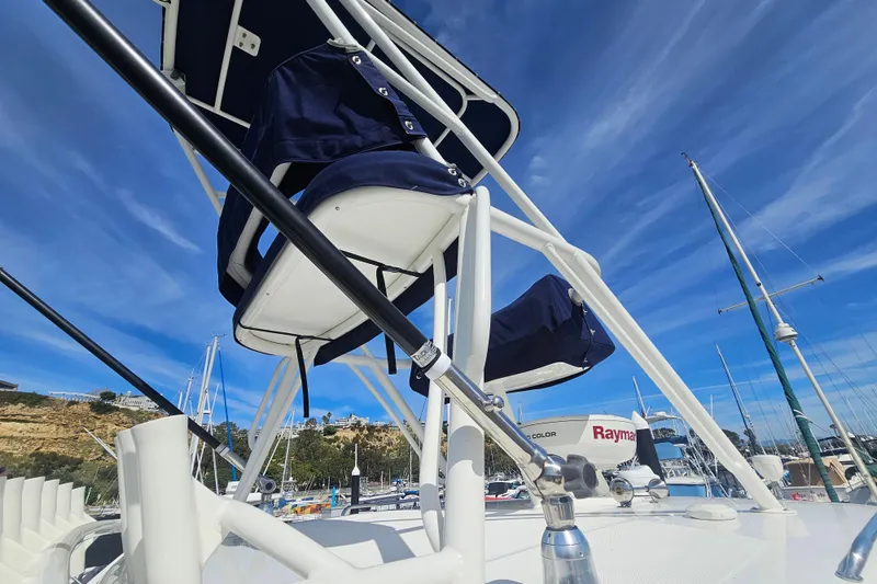 Slide: The Image of 2018 Boston Whaler 315 Conquest boat with blue sky and marina background. - 16