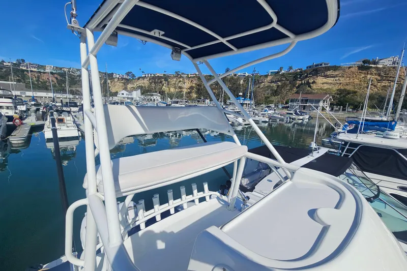 Slide: The Image of 2018 Boston Whaler 315 Conquest boat docked in a scenic marina. - 20