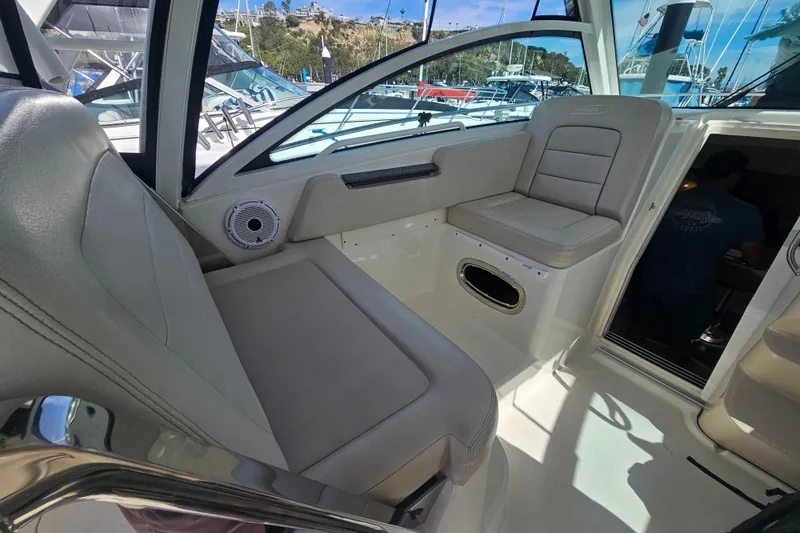 Slide: The Image of 2018 Boston Whaler 315 Conquest interior seating area with modern design and comfortable upholstery. - 24