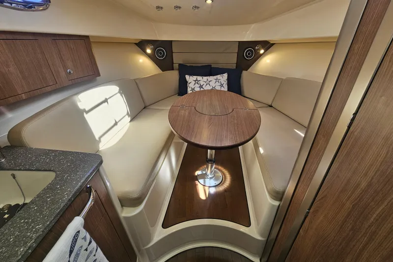 Slide: The Image of Luxurious interior of 2018 Boston Whaler 315 Conquest with cozy seating and wooden table. - 25