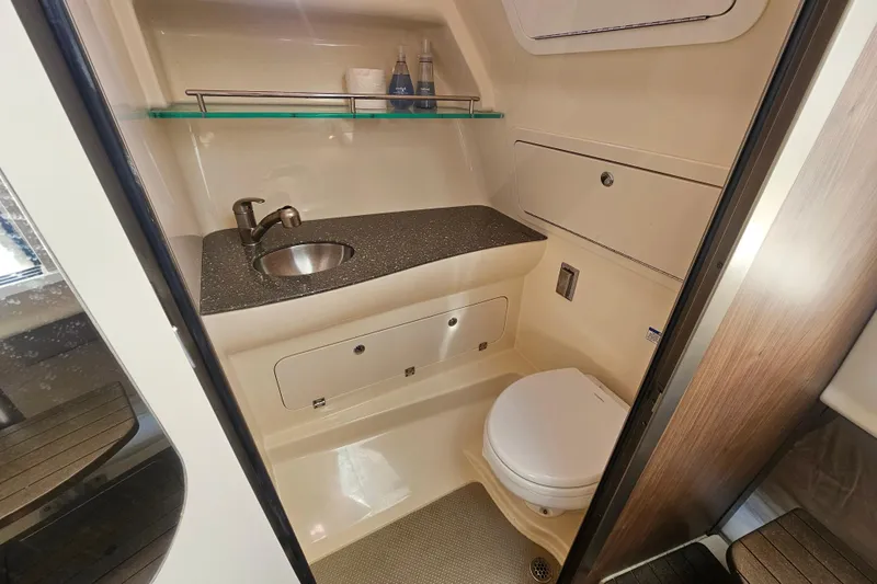 Slide: The Image of 2018 Boston Whaler 315 Conquest bathroom with sink, toilet, and storage. - 33