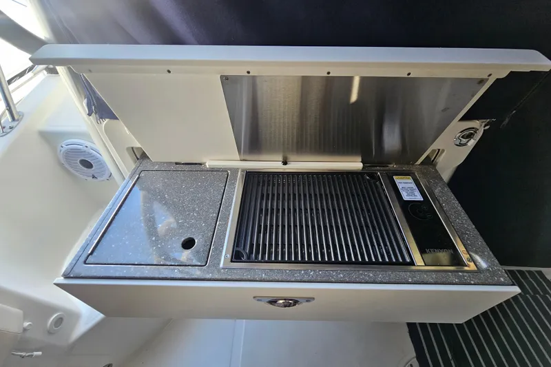 Slide: The Image of Outdoor grill and sink on a 2018 Boston Whaler 315 Conquest boat. - 34