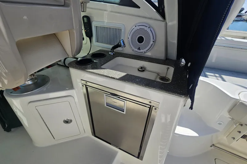 Slide: The Image of 2018 Boston Whaler 315 Conquest interior with sink, storage, and speaker. - 36