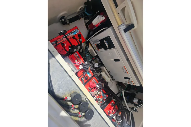 Slide: The Image of 2018 Boston Whaler 315 Conquest engine compartment with batteries and generator. - 38