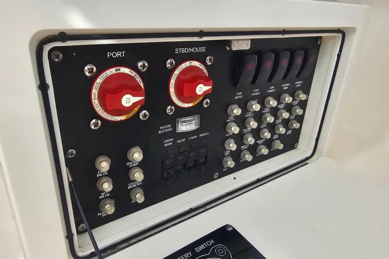 Slide: The Image of Control panel of a 2018 Boston Whaler 315 Conquest boat with switches and dials. - 39