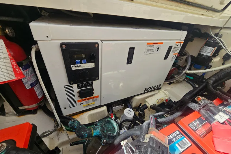 Slide: The Image of Engine compartment of 2018 Boston Whaler 315 Conquest with Kohler generator and fire extinguisher. - 40