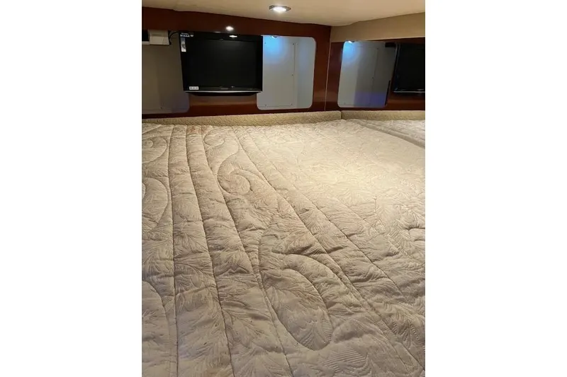 Slide: The Image of Interior cabin of 2009 Formula 350 Sun Sport with quilted bedding and TV. - 10