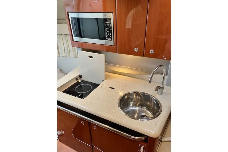 Slide: The Image of 2009 Formula 350 Sun Sport yacht kitchenette with microwave, sink, and stove. - 14
