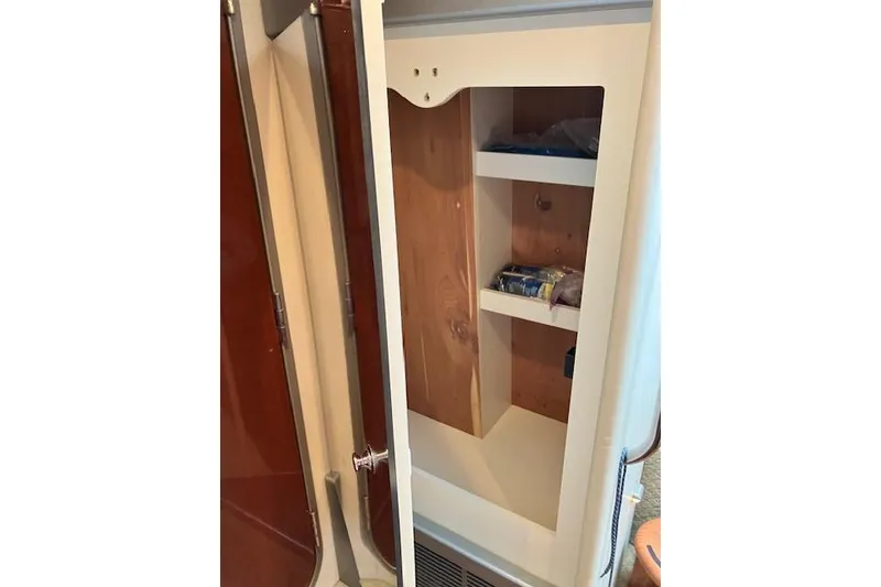 Slide: The Image of Open cabinet with shelves inside a 2009 Formula 350 Sun Sport boat. - 16