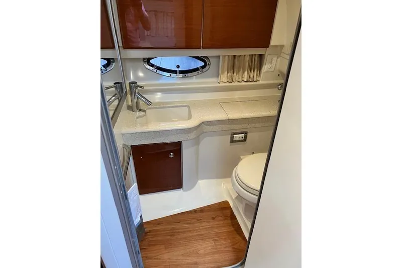 Slide: The Image of 2009 Formula 350 Sun Sport boat bathroom with sink, toilet, and wooden flooring. - 17