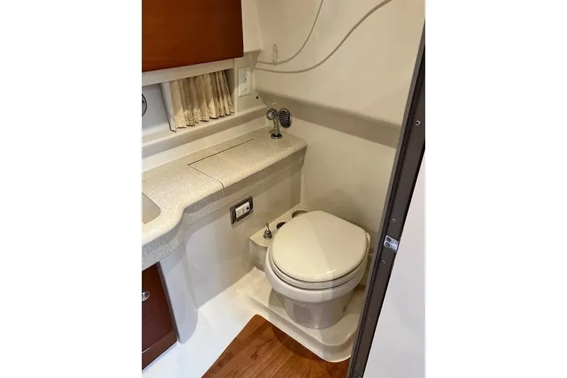 Slide: The Image of 2009 Formula 350 Sun Sport boat bathroom with compact toilet and sink. - 18