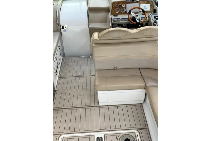 Slide: The Image of 2009 Formula 350 Sun Sport boat interior with beige seating and wooden dashboard. - 19