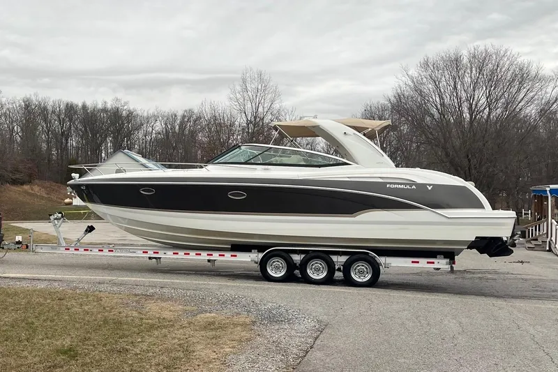 Slide: The Image of 2009 Formula 350 Sun Sport boat on trailer, parked outdoors, overcast sky. - 2