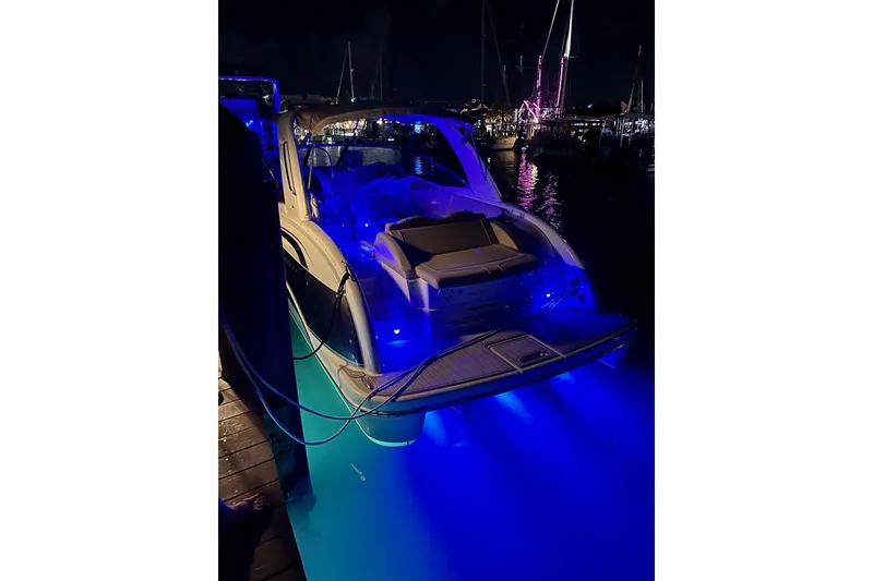 Slide: The Image of 2009 Formula 350 Sun Sport boat with blue underwater lights at night. - 3