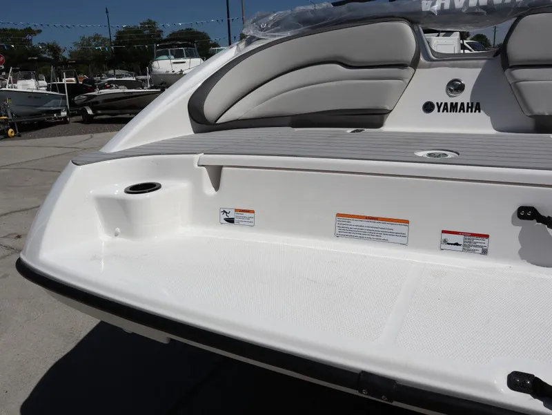 Slide: The Image of Yamaha Boats SX190 2026, rear view with seating area and brand logo. - 23