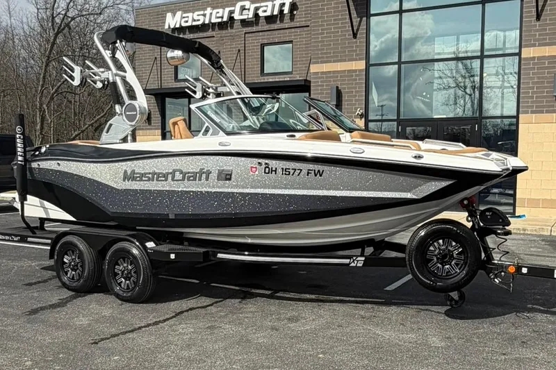 Slide: The Image of 2019 MasterCraft XT20 boat on trailer outside dealership. - 1