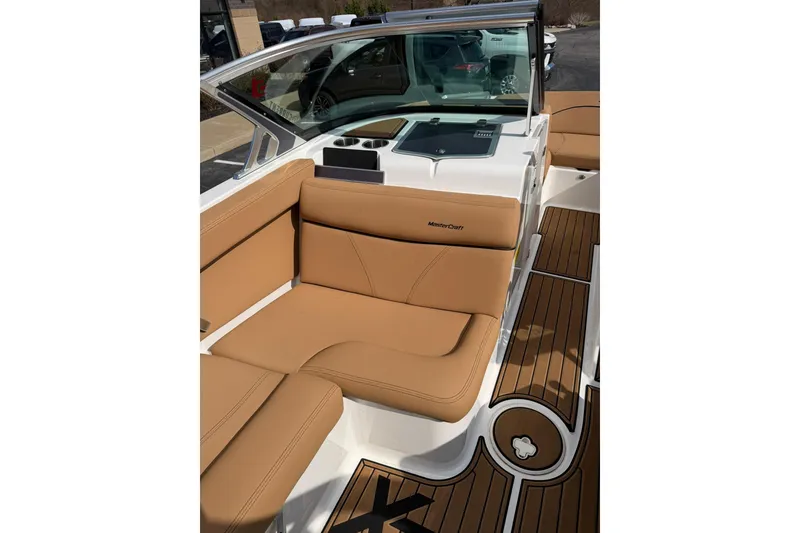 Slide: The Image of 2019 MasterCraft XT20 boat interior with tan seating and teak-style flooring. - 6