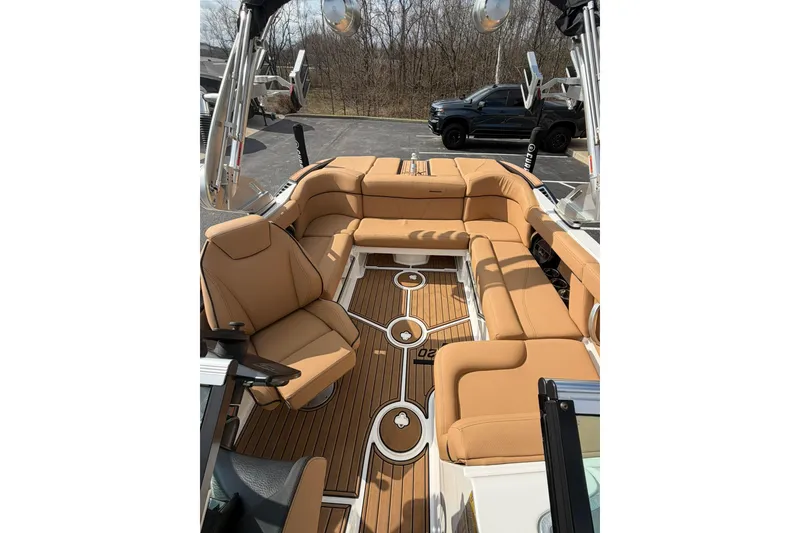 Slide: The Image of 2019 MasterCraft XT20 boat interior with tan seating and wood flooring. - 7