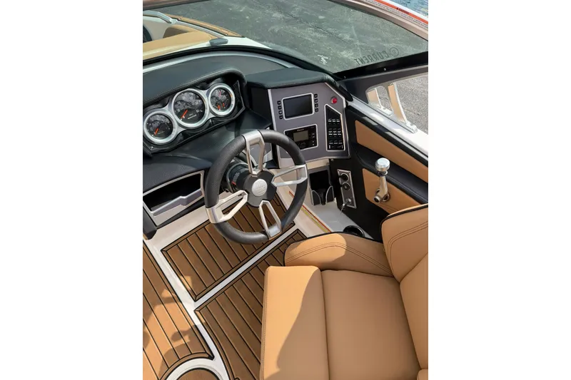 Slide: The Image of 2019 MasterCraft XT20 boat interior with modern dashboard and tan seating. - 8