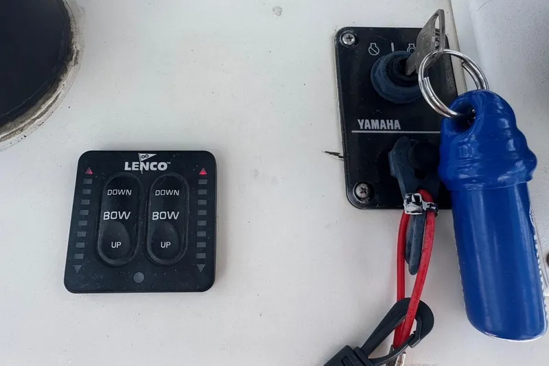 Slide: The Image of Control panel of a 1998 Legacy Boat 220 Sea Era with Lenco and Yamaha components. - 12