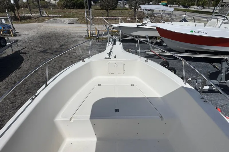Slide: The Image of 1998 Legacy Boat 220 Sea Era, white deck view, parked on trailer. - 14
