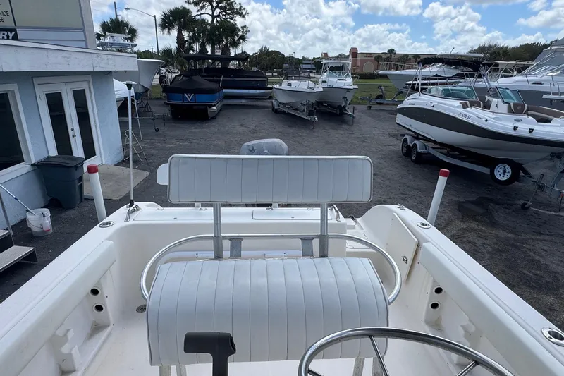 Slide: The Image of 1998 Legacy Boat 220 Sea Era at a marina with other boats. - 17